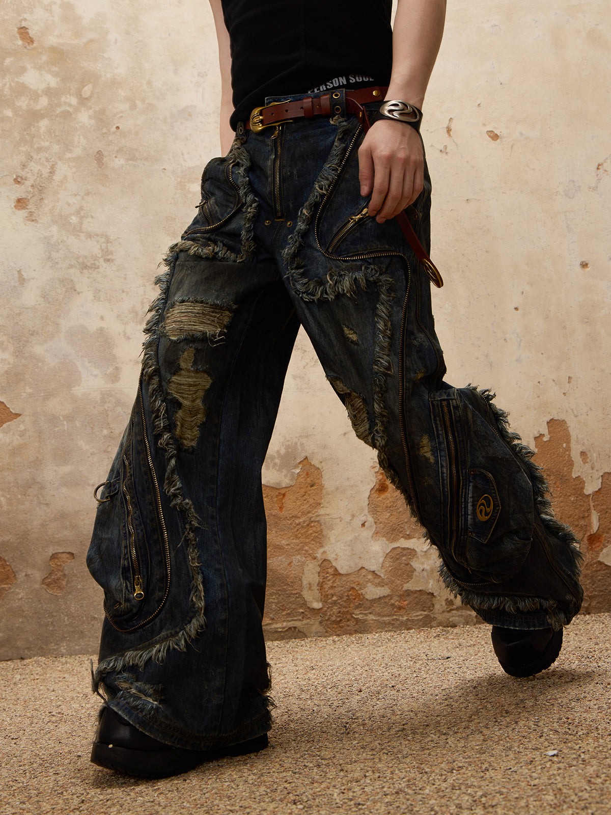 The Alien Dirty Denim Jeans feature a unique frayed design, unisex distressed detailing, and a modern, relaxed fit. 