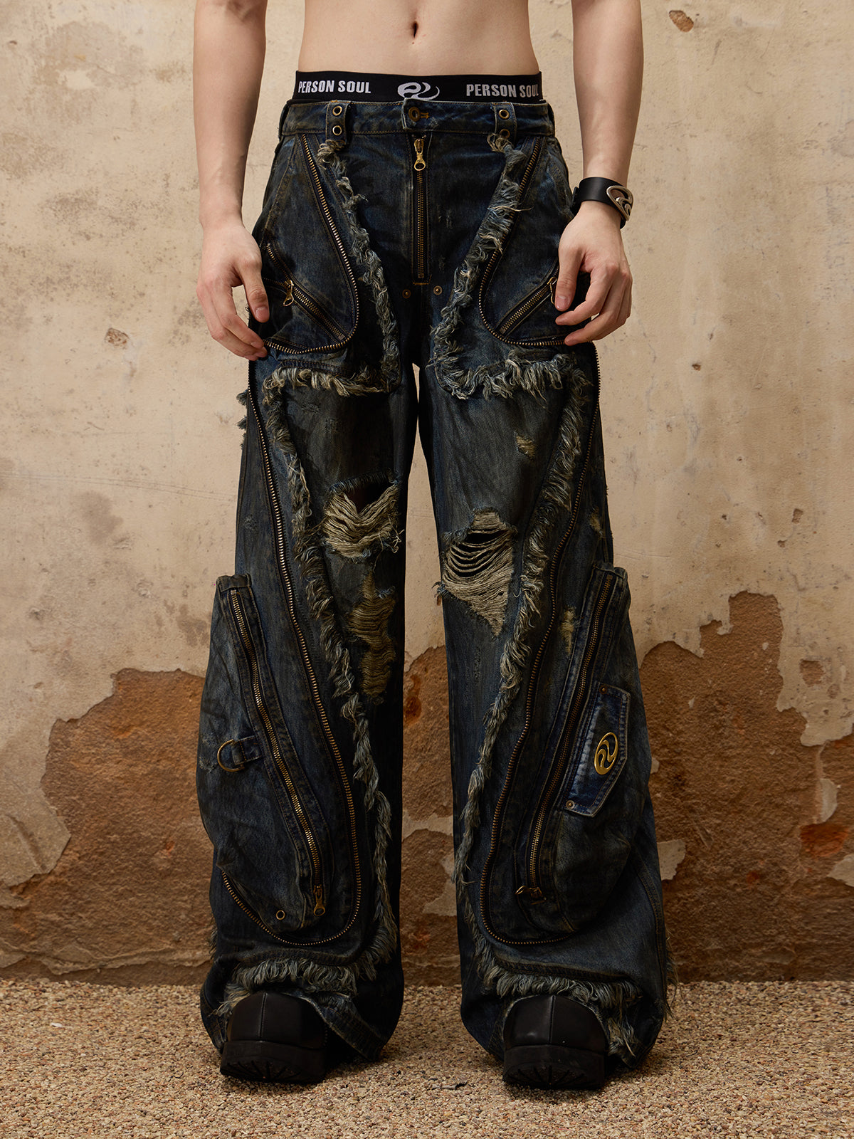 The Alien Dirty Denim Jeans feature a unique frayed design, unisex distressed detailing, and a modern, relaxed fit. 