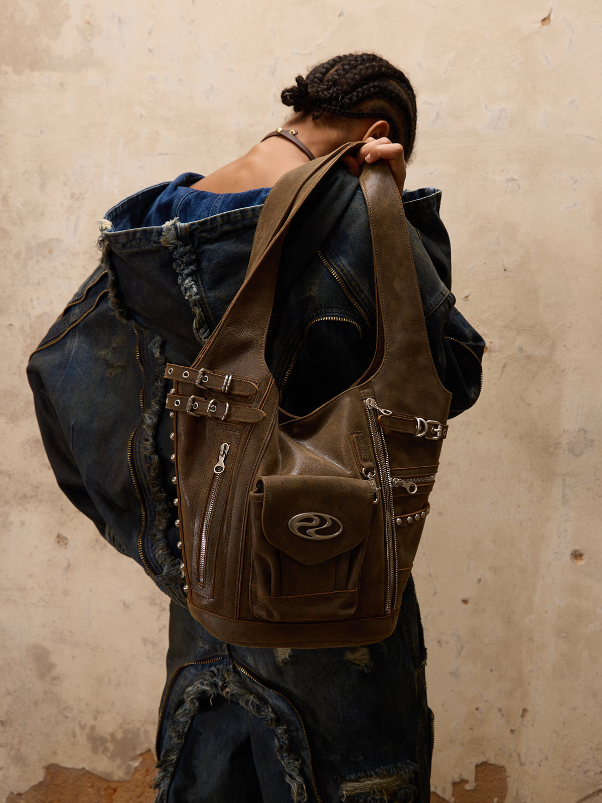 Brown leather shoulder bag with unique design and style